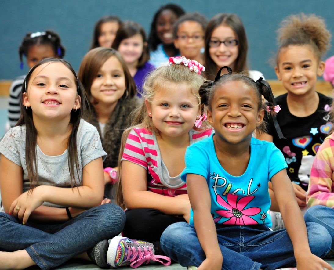 A diverse group of children sitting on the floor